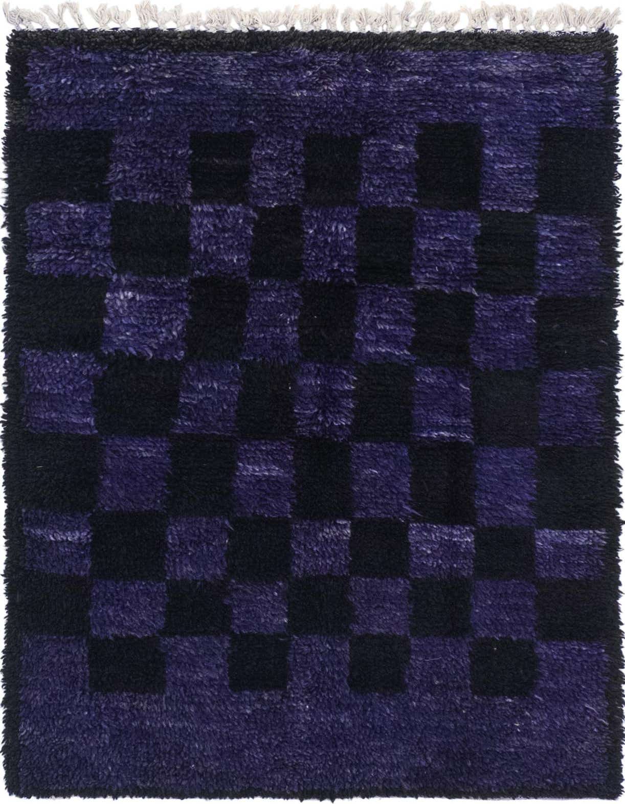 A 3x5 rectangular purple shag rug with a bold black and purple checkerboard pattern, featuring visible fringe.
