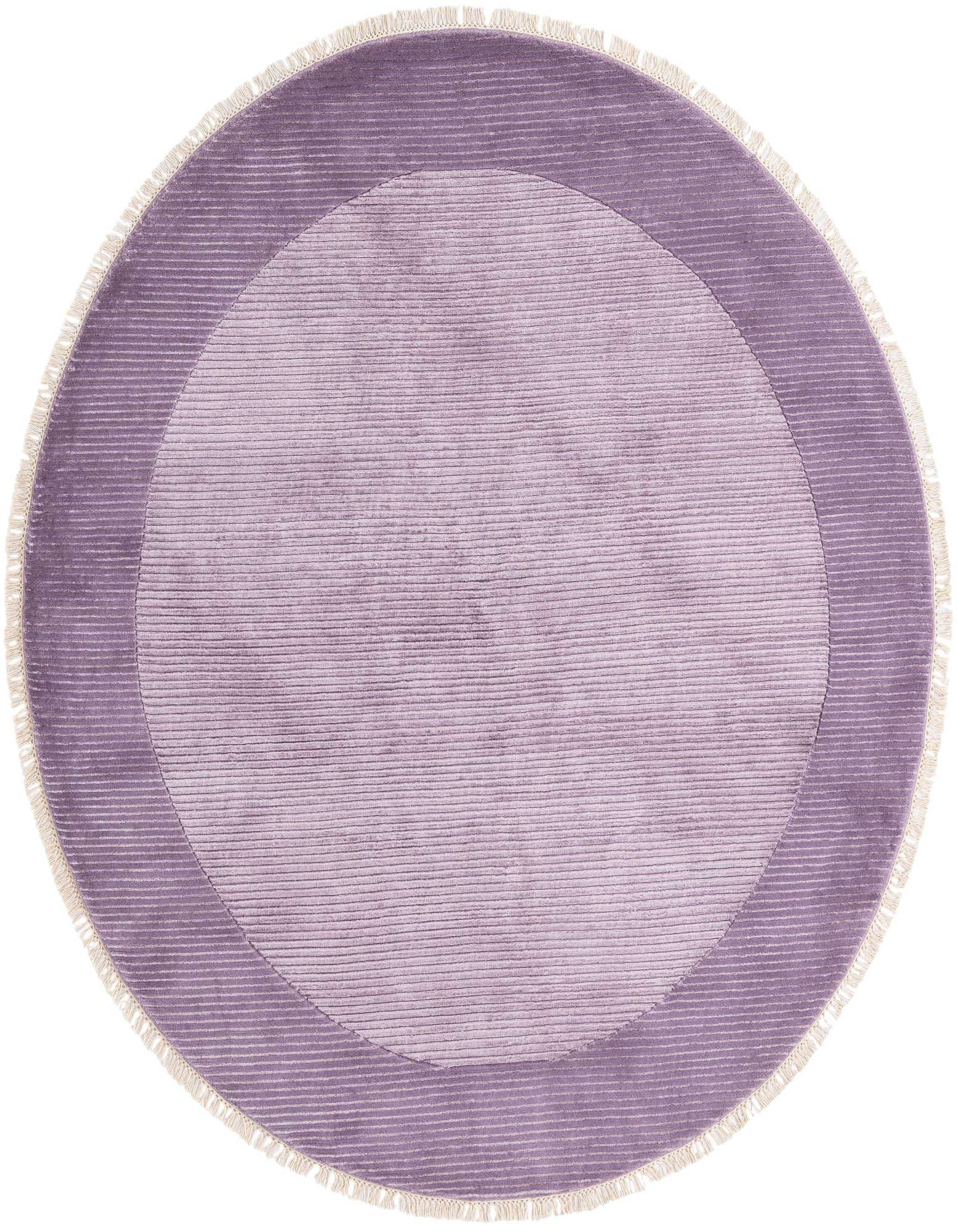 A round purple wool rug with a lighter purple center and darker purple border, featuring fringe.