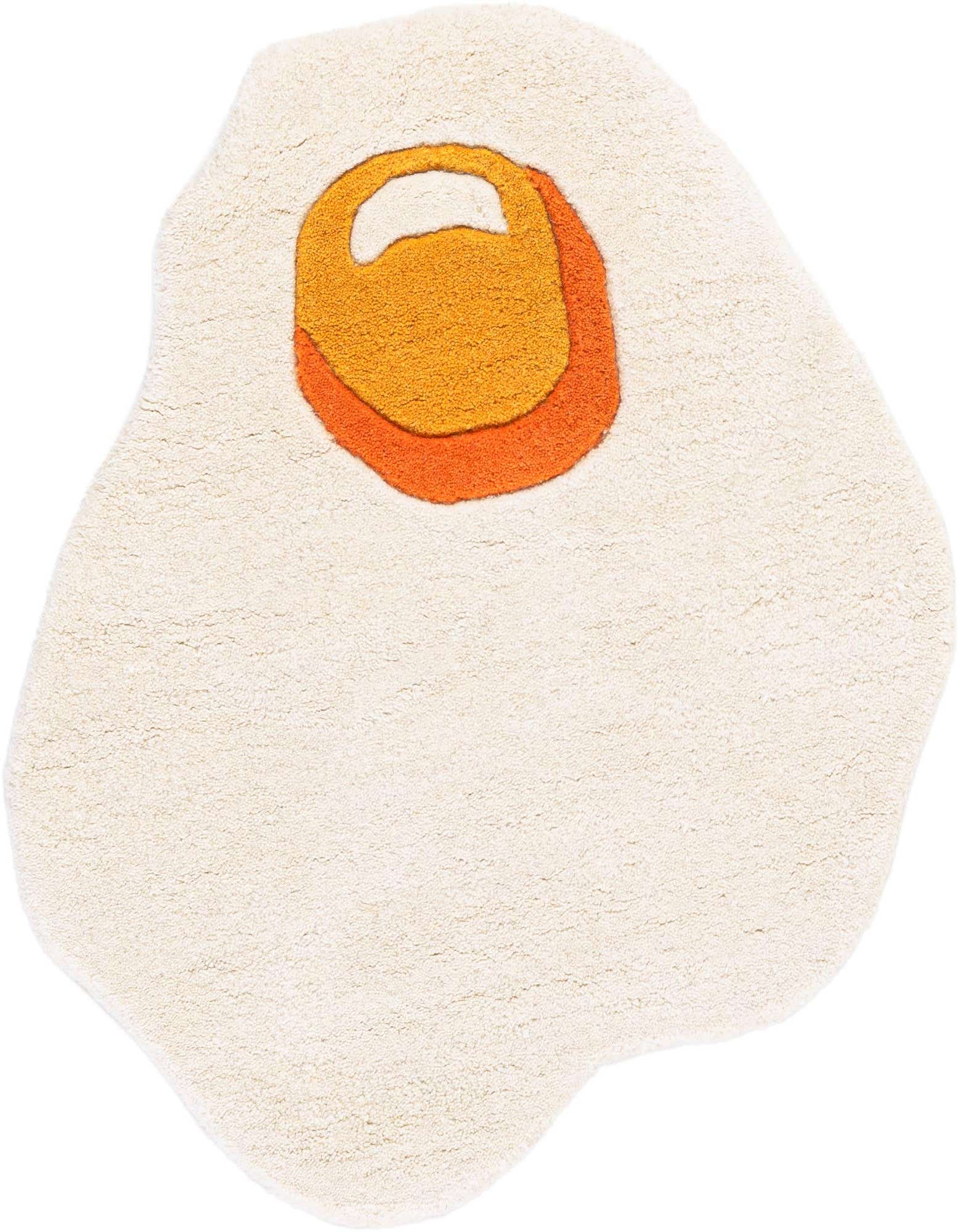 A playful freeform rug shaped like a fried egg, with a white 'egg white' and a bright orange and yellow 'yolk' at the top.