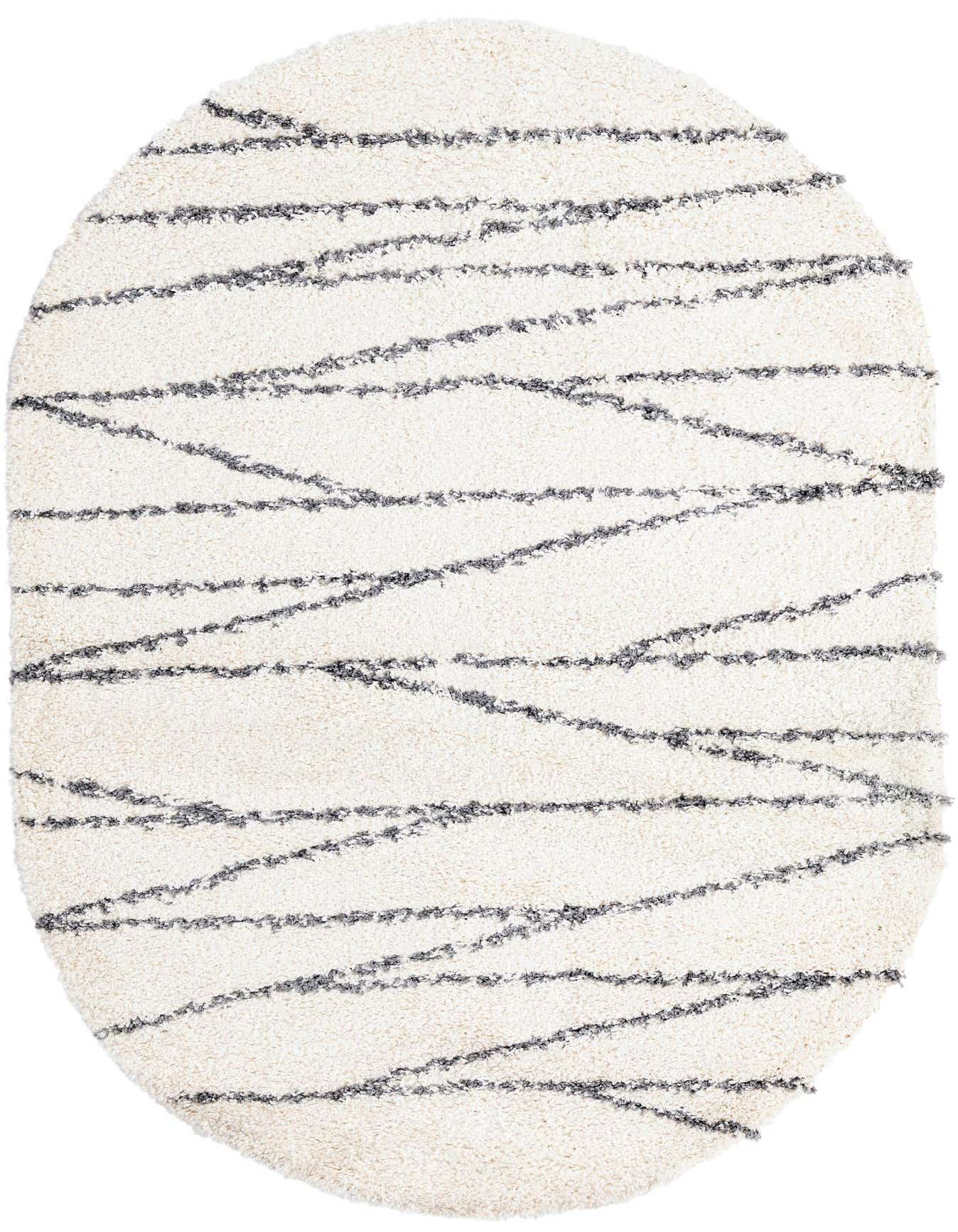 An oval 5'3" x 8'0" white shag rug with textured gray stripe patterns, suitable for modern indoor spaces.