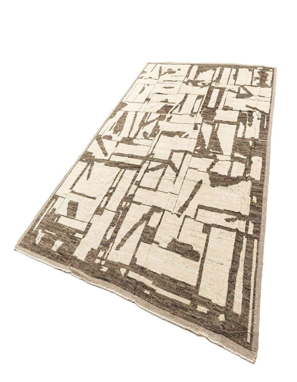 A rectangular Beni Marok rug with a modern abstract pattern in off-white and dark brown, showcasing its medium pile.