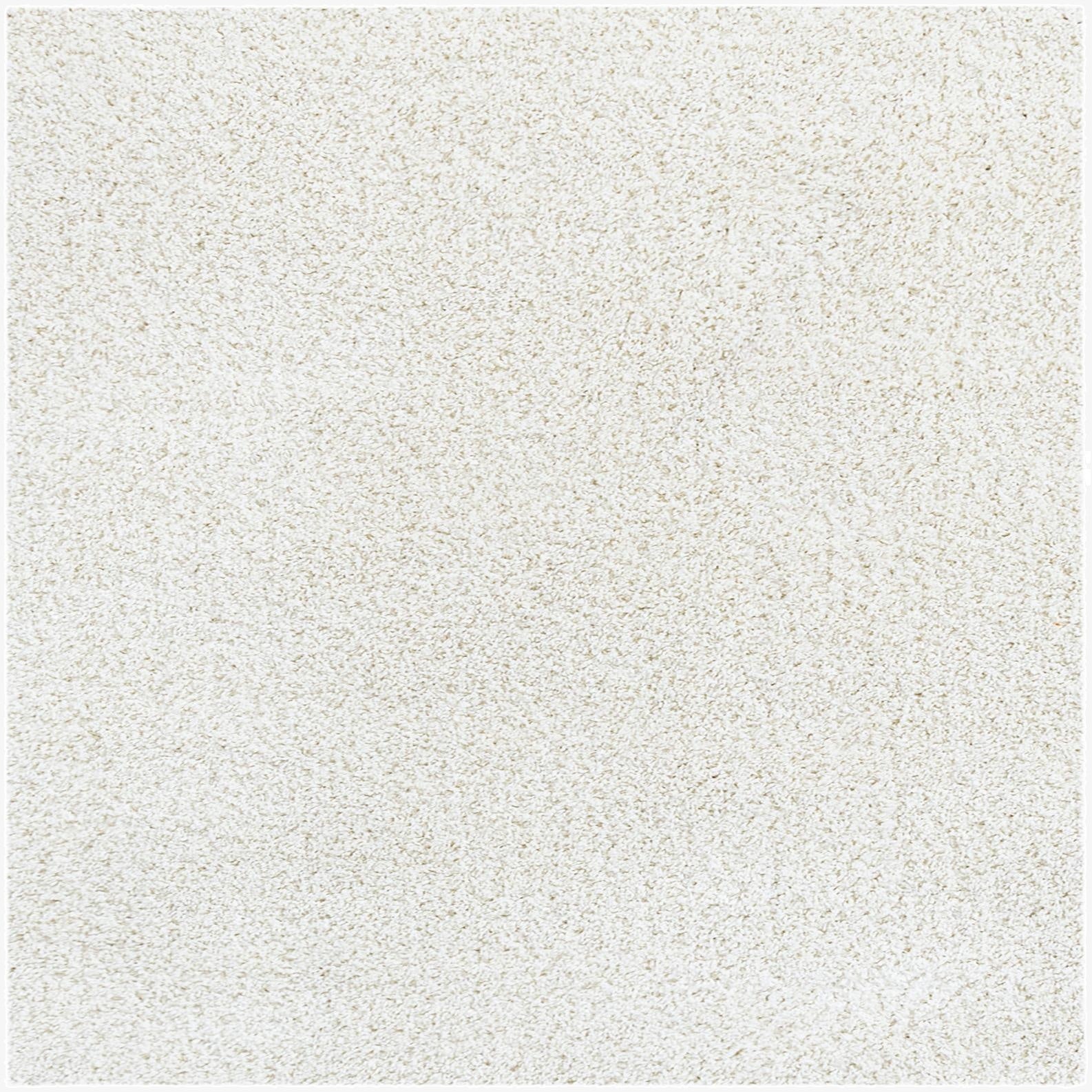 A close-up view of a plush, soft white shag rug, showcasing its dense, textured pile and inviting feel.