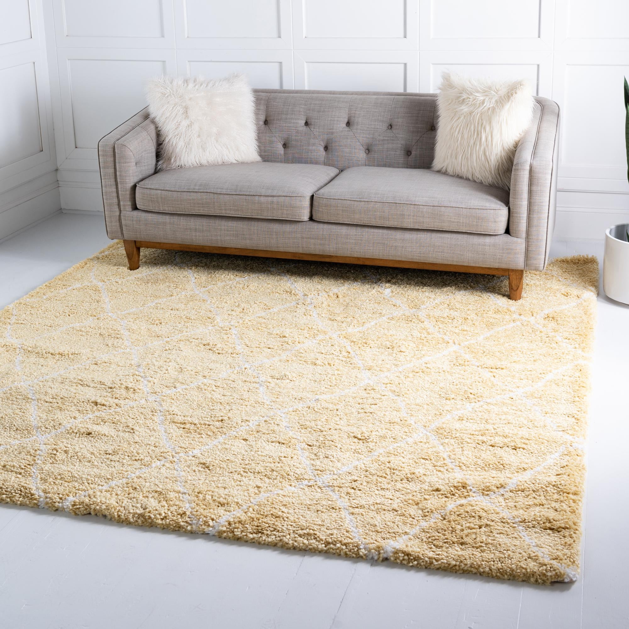 A square yellow shag rug with a white diamond trellis pattern, offering a soft, textured feel.